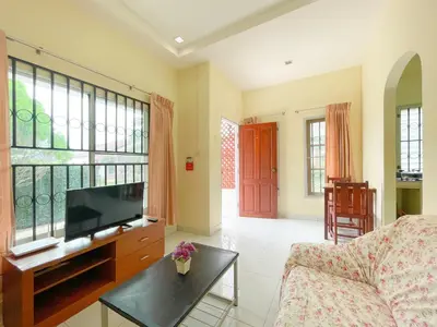 a living room with a couch and a flat screen tv at The Endless Bangtao Residence TV2 AND TV 3 in Bang Tao Beach