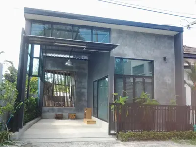 a house with an open door with plants on it at The Endless Bangtao Residence CAC 4 in Bang Tao Beach