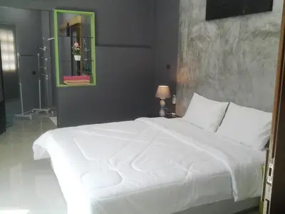 a bedroom with a white bed and a mirror at The Endless Bangtao Residence CAC 4 in Bang Tao Beach