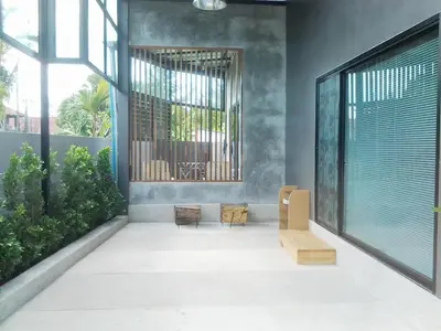 a room with two chairs and a large window at The Endless Bangtao Residence CAC 4 in Bang Tao Beach