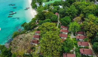 an aerial view of a beach with trees and houses at Bayview Resort Phi Phi Island - Beach Front Resort in Phi Phi Don