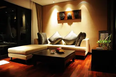 a living room with a couch and a coffee table at Niramaya Villa & Wellness in Ko Yao Noi