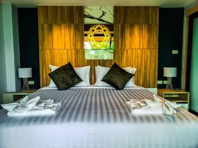 a bedroom with a bed with two pairs of shoes on it at Niramaya Villa & Wellness in Ko Yao Noi