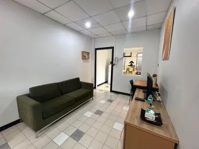 a living room with a green couch and a table at The Endless Bangtao Residence CAC 2 in Bang Tao Beach