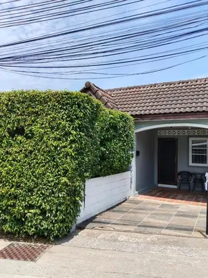 a hedge in front of a house at The Endless Bangtao Residence CAC 2 in Bang Tao Beach