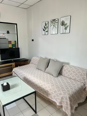 a living room with a bed and a tv at The Endless Bangtao Residence CAC 1 in Bang Tao Beach
