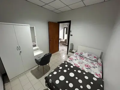 a bedroom with a bed and a chair in it at The Endless Bangtao Residence CAC 1 in Bang Tao Beach