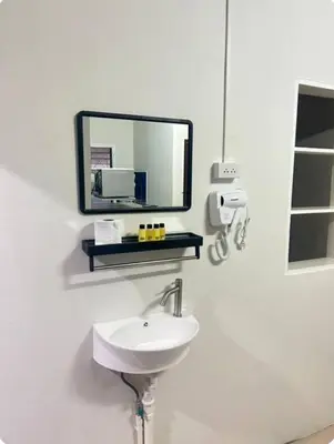 a bathroom with a sink and a mirror on the wall at The Endless Bangtao Residence PM12 in Bang Tao Beach