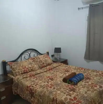 a bed with a pair of slippers sitting on it at The Endless Bangtao Residence PM12 in Bang Tao Beach