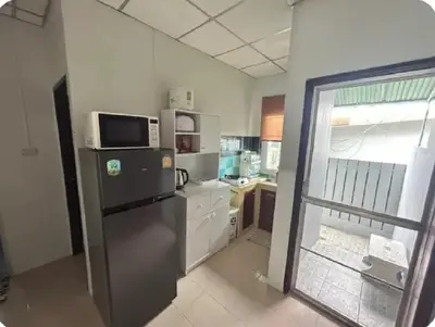 a kitchen with a refrigerator and a microwave at The Endless Bangtao Residence PM12 in Bang Tao Beach