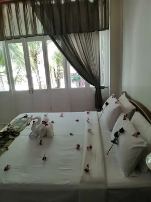 a bedroom with a bed with stuffed animals on it at Tony Home and Restaurant in Karon Beach