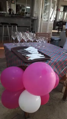 a table with pink and white balloons on it at Tony Home and Restaurant in Karon Beach