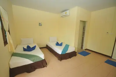a room with two beds with blue pillows on them at Sand Sea House in Phi Phi Don