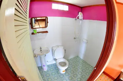 a small bathroom with a toilet and a sink at Sand Sea House in Phi Phi Don