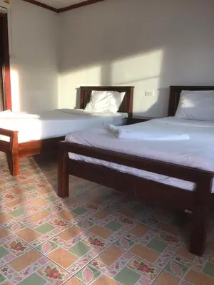 two beds sitting next to each other in a room at Sand Sea House in Phi Phi Don