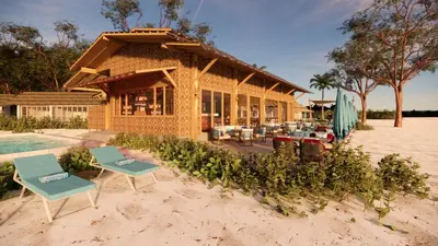 a house on the beach with chairs and a pool at OUTRIGGER Phi Phi Island Resort in Phi Phi Don