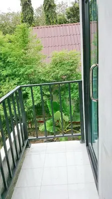 an open glass door with a view of a yard at The Endless Bangtao Residence CHAT 2 in Bang Tao Beach