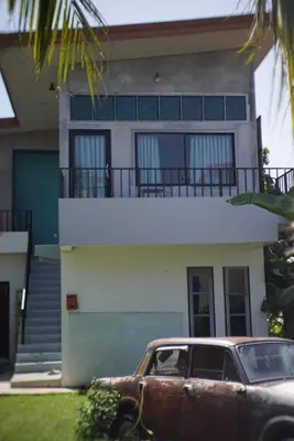 an old car parked in front of a house at The Endless Bangtao Residence CHAT 2 in Bang Tao Beach