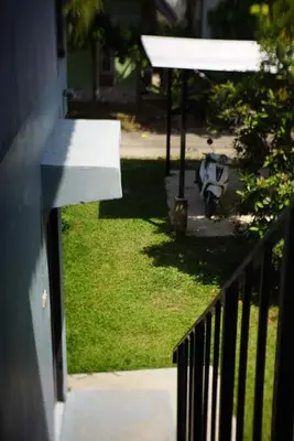 a view from a balcony of a yard with a motorcycle at The Endless Bangtao Residence CHAT 2 in Bang Tao Beach