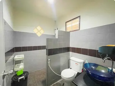 a bathroom with a toilet and a blue sink at The Endless Bangtao Residence VC 1 in Bang Tao Beach