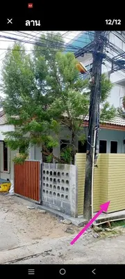 a pink kite next to a fence and a tree at The Endless Bangtao Residence VC 1 in Bang Tao Beach