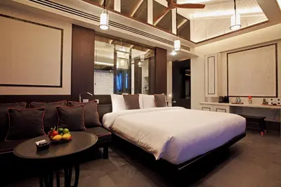 a bedroom with a large bed and a couch at Baba Beach Club Phuket Natai Luxury Pool Villa Hotel by Sri panwa in Natai Beach