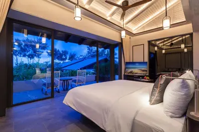 a bedroom with a large bed and a balcony at Baba Beach Club Phuket Natai Luxury Pool Villa Hotel by Sri panwa in Natai Beach