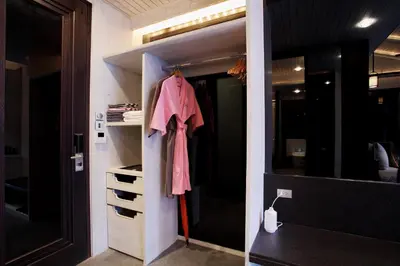 a closet with a pink shirt hanging in it at Baba Beach Club Phuket Natai Luxury Pool Villa Hotel by Sri panwa in Natai Beach
