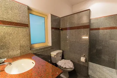 a bathroom with a sink and a toilet and a window at Viola Pool Villa Elegant Elegant Villa In Paradise in Rawai Beach