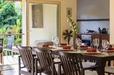 a dining room table with wine glasses and food on it at Viola Pool Villa Elegant Elegant Villa In Paradise in Rawai Beach