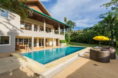 a house with a swimming pool in front of a house at Viola Pool Villa Elegant Elegant Villa In Paradise in Rawai Beach