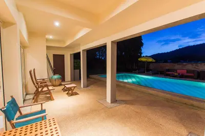 a house with a swimming pool and a patio at Viola Pool Villa Elegant Elegant Villa In Paradise in Rawai Beach