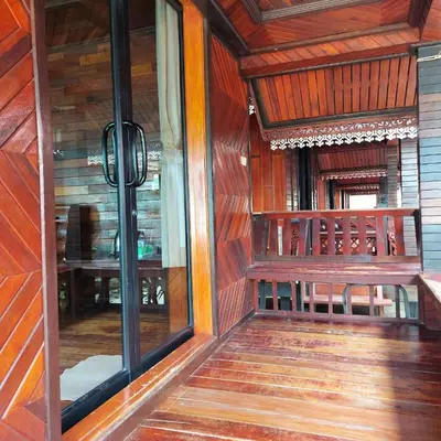 a wooden bench sitting inside of a building at Phi Phi Sand Sea View Resort in Phi Phi Don