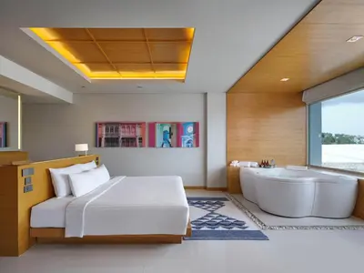 a bedroom with a bed and a bath tub at The Kee Resort & Spa in Patong Beach