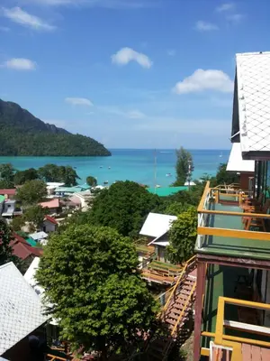 a view of a city with the ocean in the background at Phitharom PP Resort in Phi Phi Don