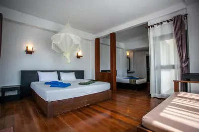 a bedroom with two beds in a room at Phitharom PP Resort in Phi Phi Don