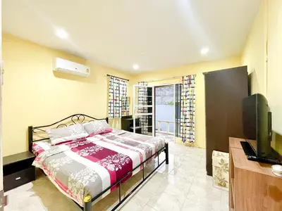 a bedroom with a bed and a flat screen tv at The Endless Resident Private Pool Villa PSU in Bang Tao Beach