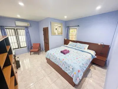 a blue bedroom with a bed and a chair at The Endless Resident Private Pool Villa PSU in Bang Tao Beach