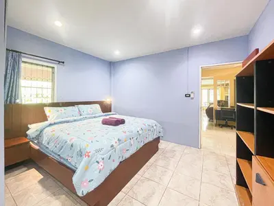 a bedroom with a large bed with blue walls at The Endless Resident Private Pool Villa PSU in Bang Tao Beach