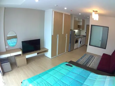 a living room with a bed and a television at Naithon condominium A-103 in Nai Thon Beach