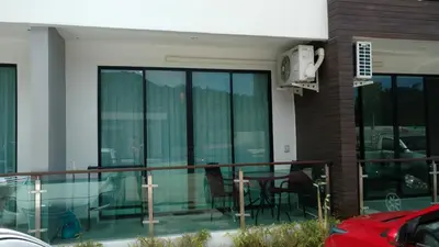 a balcony of a building with a table and chairs at Naithon condominium A-103 in Nai Thon Beach