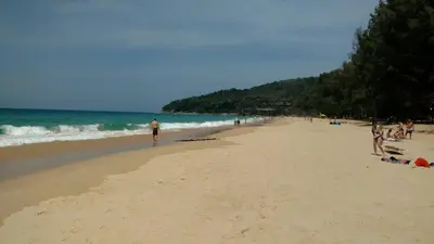 a group of people standing on a beach at Naithon condominium A-103 in Nai Thon Beach