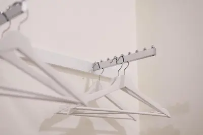 a metal rack with hangers on a wall at Shunli Hotel - SHA Extra Plus in Phuket Town