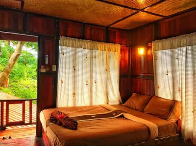 a bedroom with a bed in a room with windows at Phi Phi Green Hill Resort in Phi Phi Don