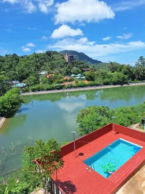 a swimming pool on a red roof next to a river at Phi Phi Green Hill Resort in Phi Phi Don