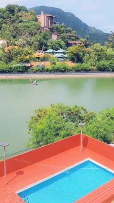 a swimming pool on a deck next to a body of water at Phi Phi Green Hill Resort in Phi Phi Don