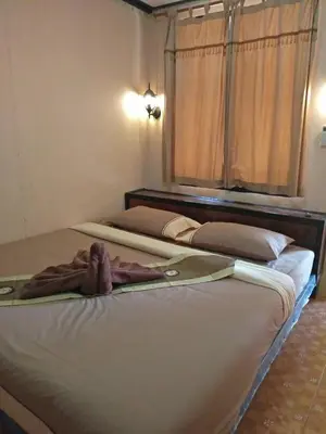 two beds sitting next to each other in a room at Phi Phi Green Hill Resort in Phi Phi Don