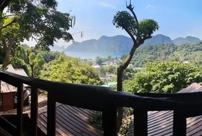 a wooden deck with a view of the mountains at Phi Phi Green Hill Resort in Phi Phi Don