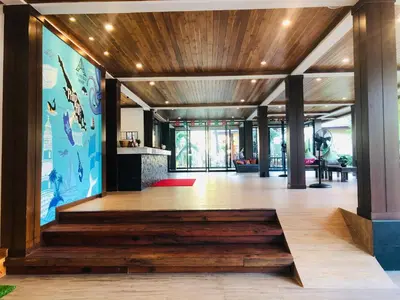 a lobby with a wooden floor and a large mural at Phi Phi Villa Resort in Phi Phi Don