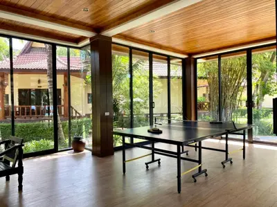 a dining room with a table and large glass windows at Phi Phi Villa Resort in Phi Phi Don